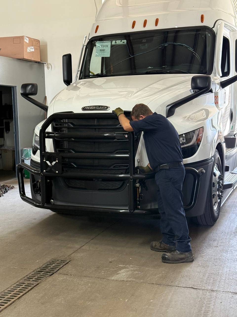 MKZ technician repairing a truck in the shop